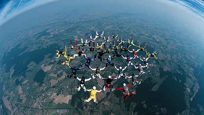 Skydivers forming a circle mid-air