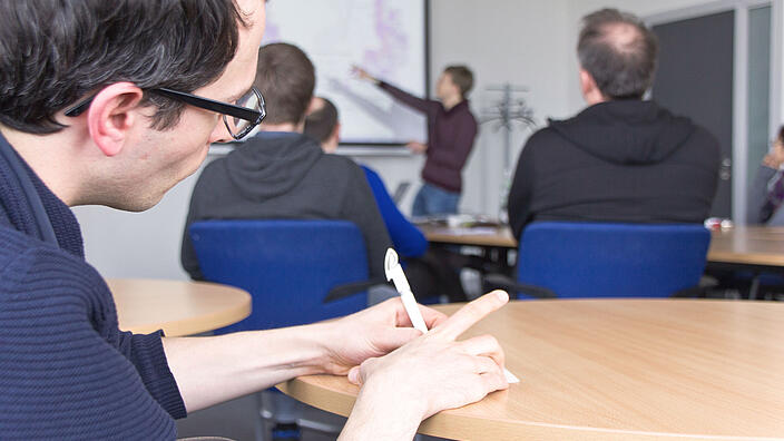 Attendee taking notes during a seminar